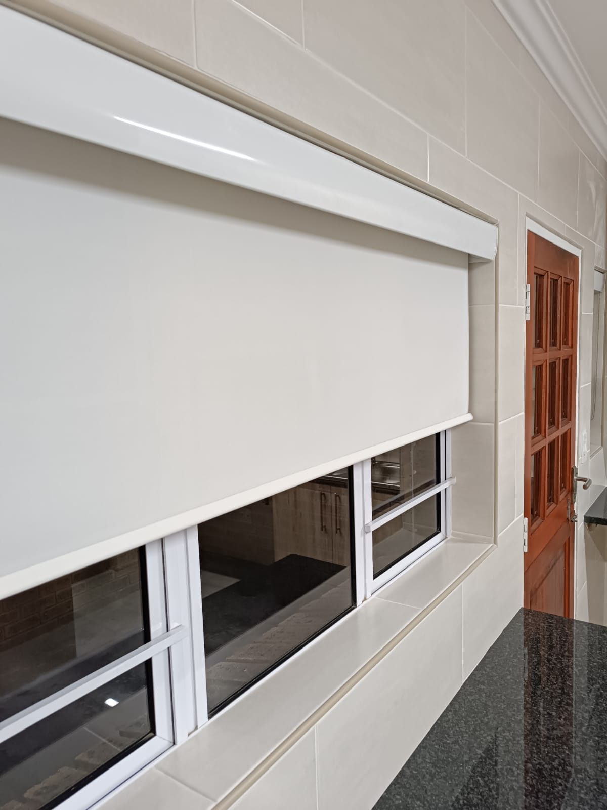 White roller blind in a tiled kitchen